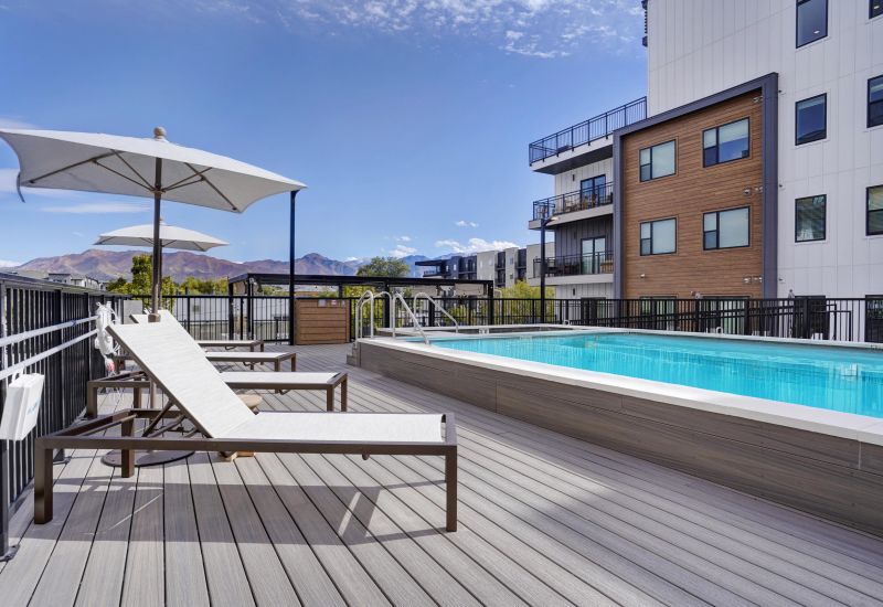 Resort-style pool deck with mountain views at The Whitney apartments in Salt Lake City, Utah