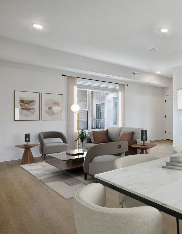Modern open-concept living and dining area with light wood floors, neutral decor, and minimalist furniture.