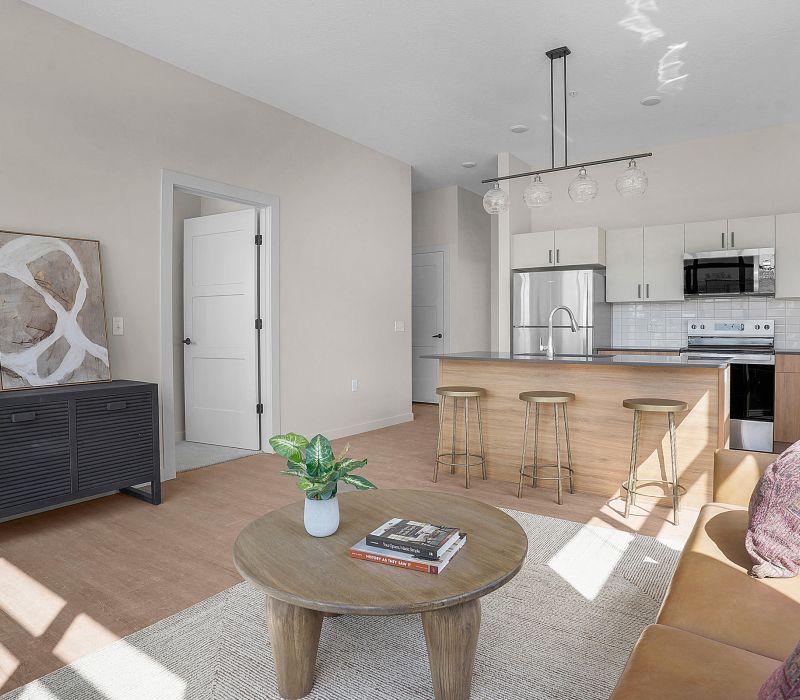 Spacious living room and kitchen with contemporary finishes at The Whitney apartments in Salt Lake City, Utah